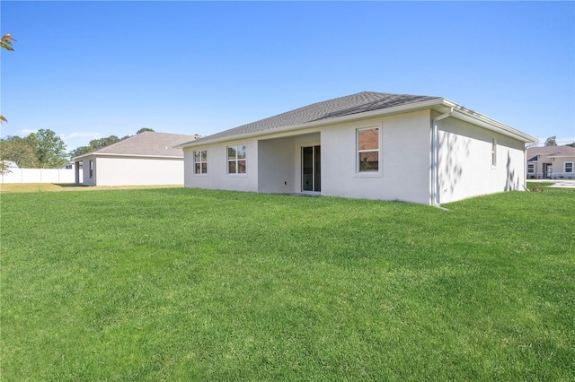 rear view of property with a lawn