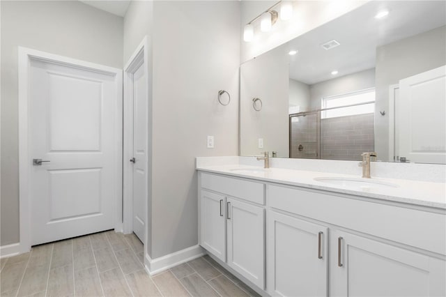 bathroom featuring vanity, hardwood / wood-style flooring, and walk in shower