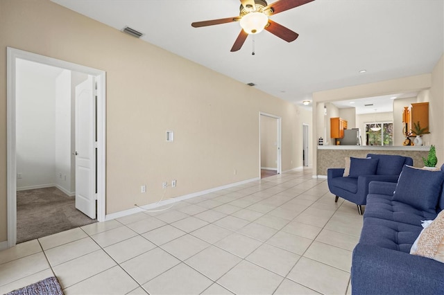 unfurnished living room with light tile patterned flooring and ceiling fan