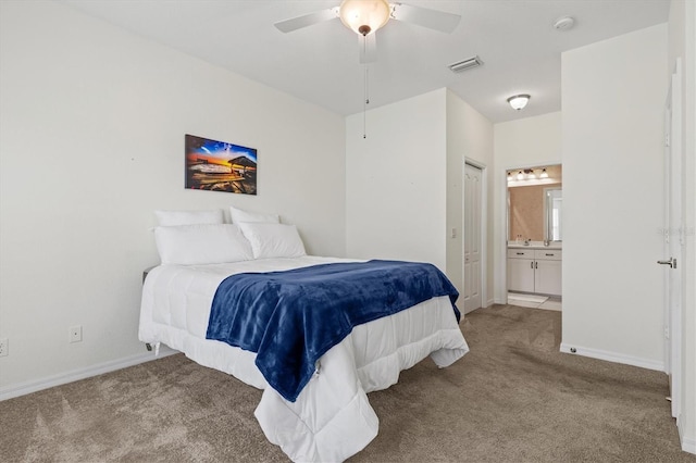 carpeted bedroom featuring ceiling fan and connected bathroom