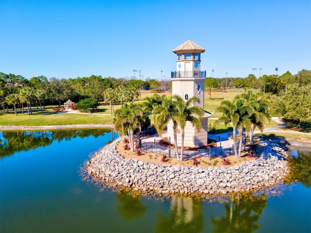 view of property's community with a yard and a water view