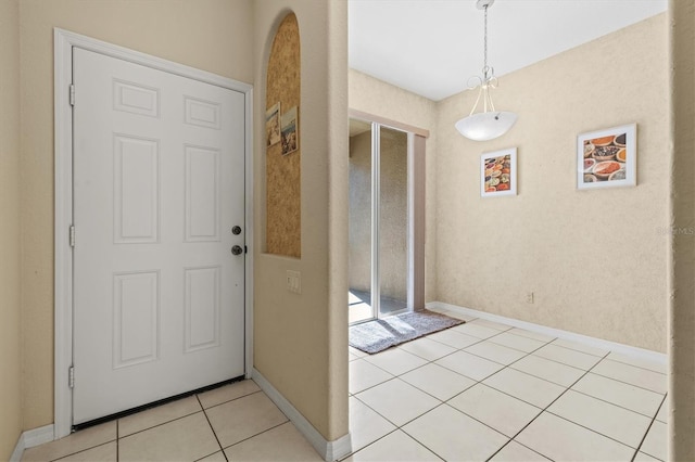 foyer entrance featuring light tile patterned flooring