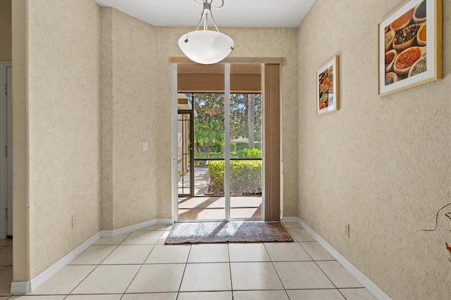 doorway to outside featuring light tile patterned floors