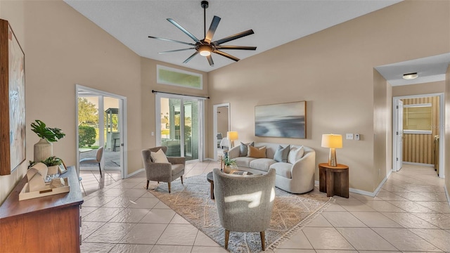 living room with high vaulted ceiling, ceiling fan, and light tile patterned floors