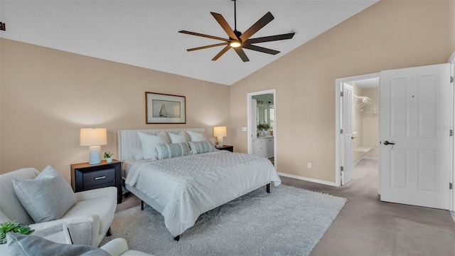 carpeted bedroom featuring a spacious closet, ensuite bathroom, ceiling fan, and high vaulted ceiling