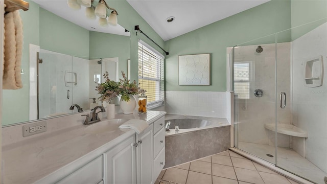 bathroom with tile patterned floors, vanity, lofted ceiling, and separate shower and tub