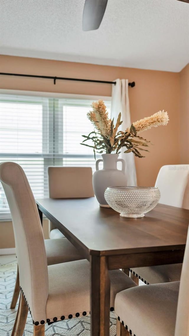 dining room with carpet flooring and a textured ceiling