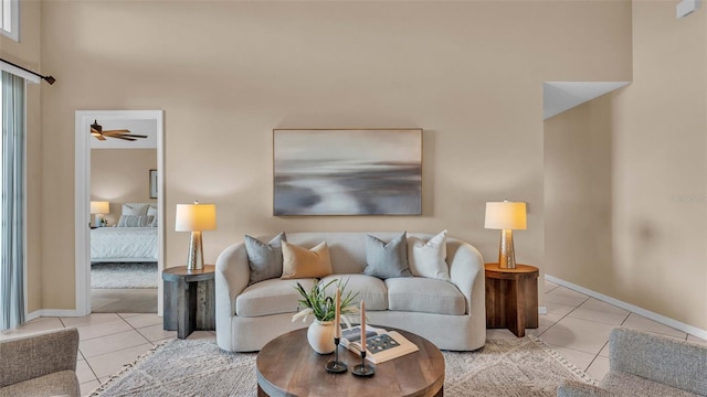 living room with ceiling fan and light tile patterned floors