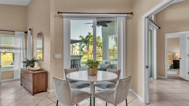 interior space featuring light tile patterned floors and ceiling fan