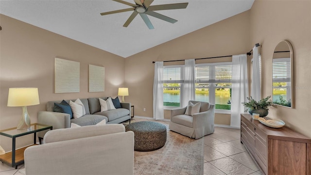 living room featuring high vaulted ceiling, a wealth of natural light, a water view, and ceiling fan