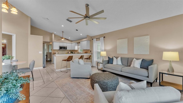 living room featuring ceiling fan, light tile patterned floors, and high vaulted ceiling