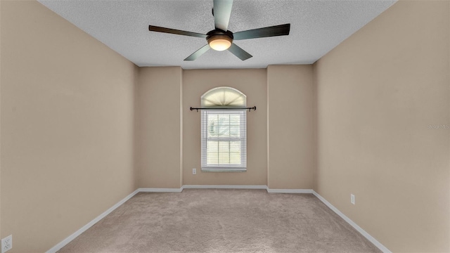 spare room with light carpet, a textured ceiling, and ceiling fan