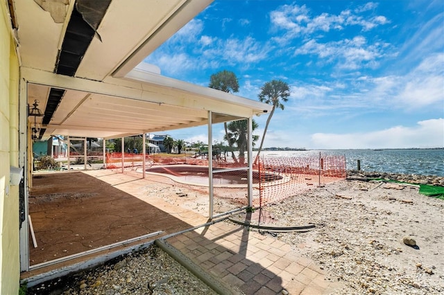 view of patio with a water view