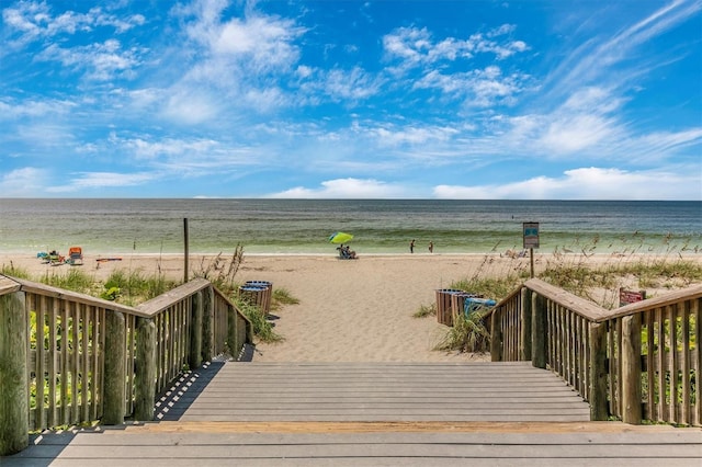 view of property's community featuring a water view and a view of the beach