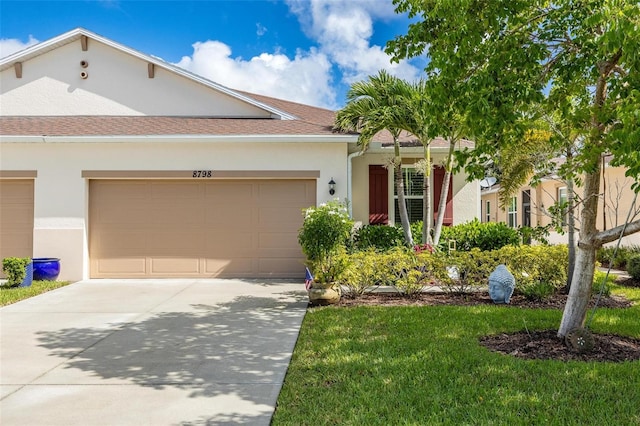 view of front of house with a garage and a front yard