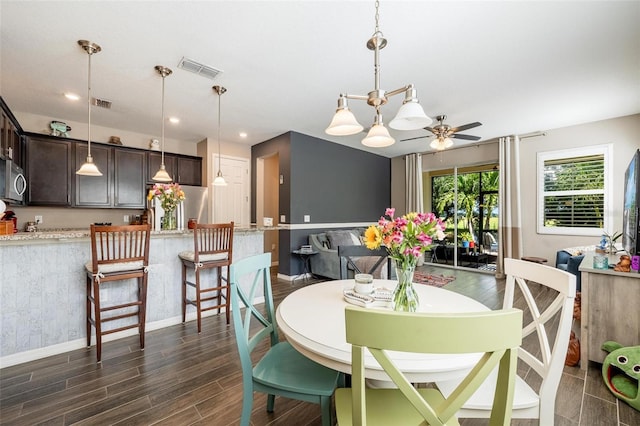 dining area with ceiling fan and dark hardwood / wood-style flooring