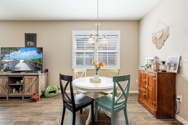 8798 Tuscany Isles Dr, Punta Gorda, FL 33950 - dining space with an inviting chandelier, baseboards, and wood tiled floor