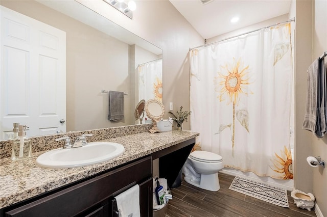 bathroom with vanity, toilet, and hardwood / wood-style flooring