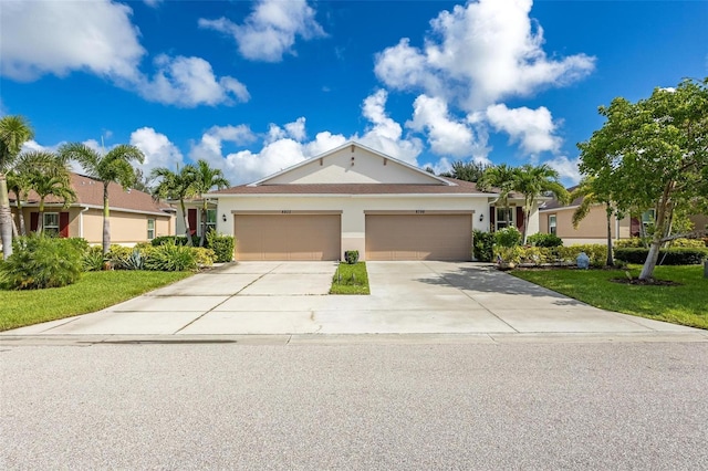 8798 Tuscany Isles Dr, Punta Gorda, FL 33950 - ranch-style home with stucco siding, driveway, a garage, and a front lawn
