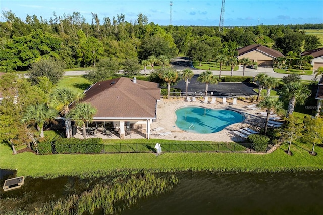 view of swimming pool with a water view, a lawn, and a patio