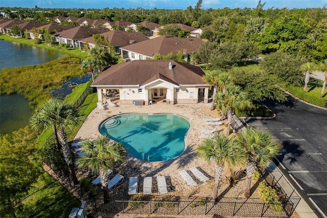 view of swimming pool with a water view and a patio area