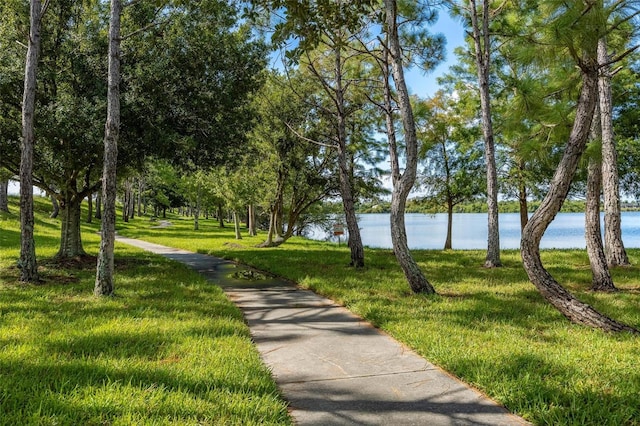 surrounding community featuring a water view and a yard