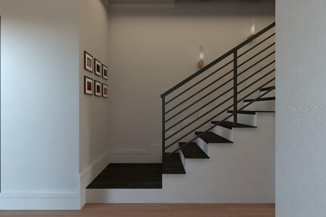 stairs with hardwood / wood-style flooring