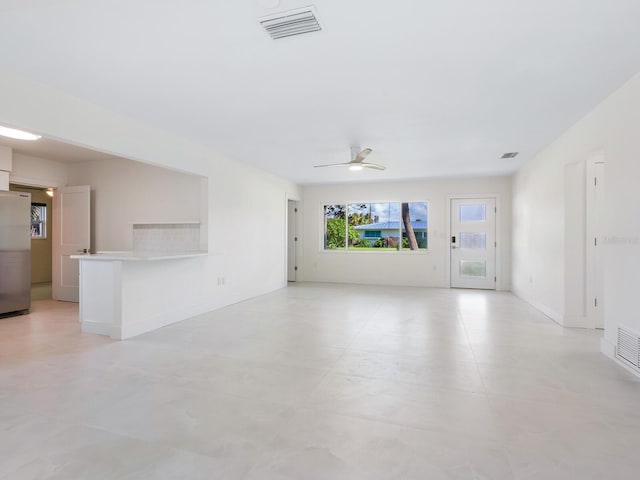 unfurnished living room with ceiling fan