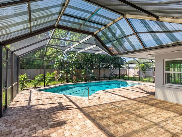 view of swimming pool featuring a lanai, a patio area, and ceiling fan