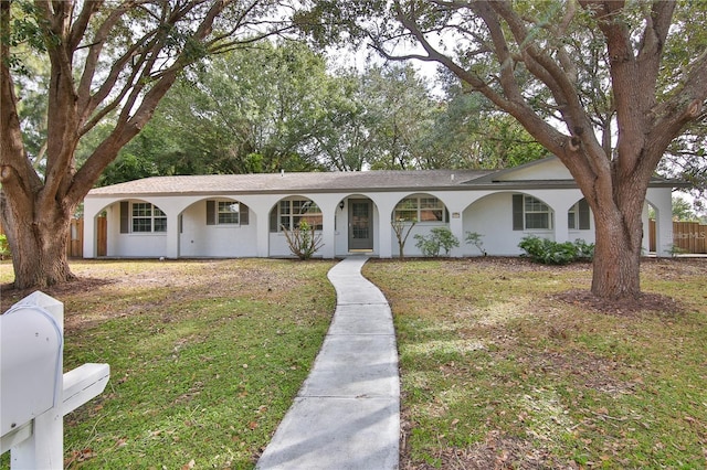 ranch-style house with a front lawn