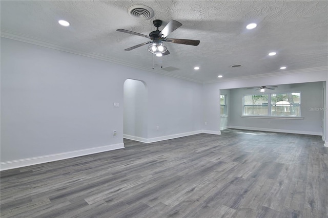 unfurnished living room featuring ceiling fan, dark hardwood / wood-style flooring, crown molding, and a textured ceiling