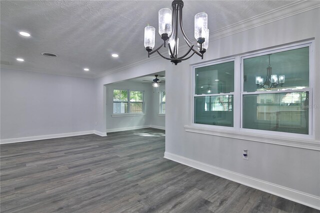 unfurnished dining area featuring ceiling fan with notable chandelier, ornamental molding, dark hardwood / wood-style flooring, and a textured ceiling