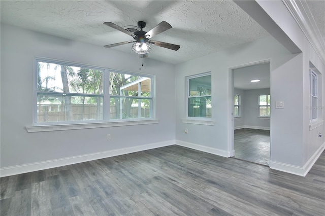 unfurnished room featuring a textured ceiling, dark wood-type flooring, and ceiling fan