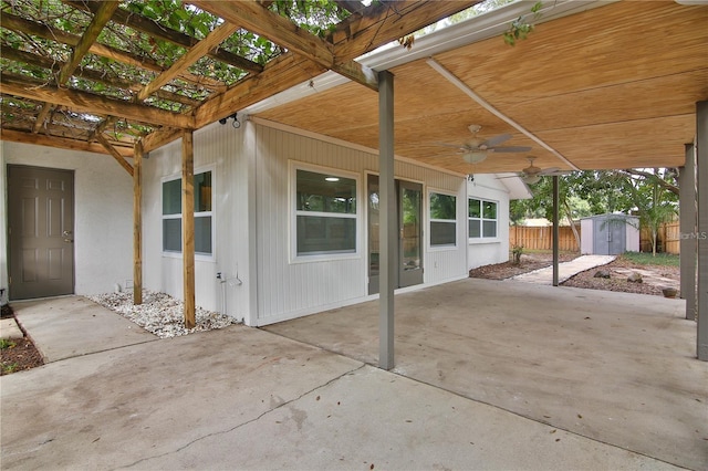 view of patio / terrace with a storage unit, ceiling fan, and a pergola