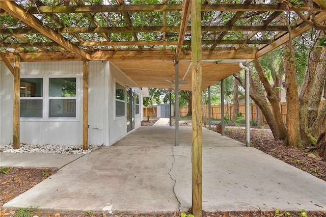 2912 Pinecrest Way, Sarasota, FL 34239 - fenced backyard featuring a pergola, a patio area, a storage unit, and a carport