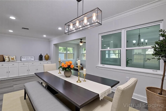 2912 Pinecrest Way, Sarasota, FL 34239 - dining space featuring a chandelier, dark wood-type flooring, crown molding, recessed lighting, and a ceiling fan