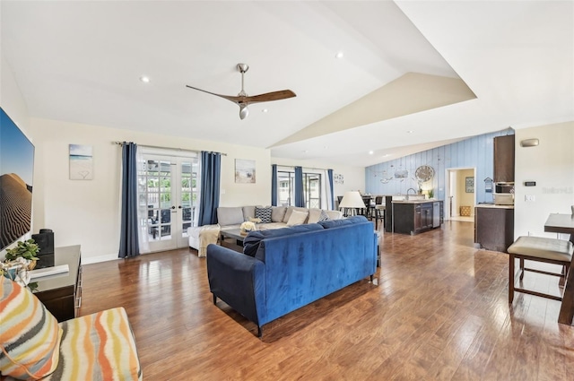 living room with a ceiling fan, wood finished floors, recessed lighting, vaulted ceiling, and french doors