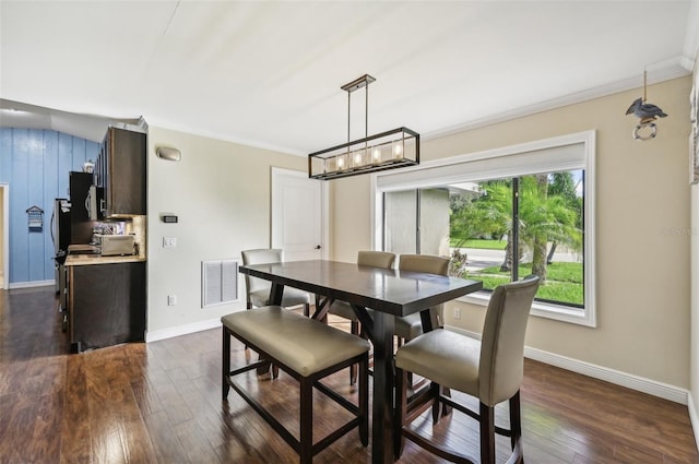 dining space with visible vents, a notable chandelier, ornamental molding, baseboards, and dark wood-style flooring