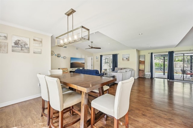 dining space featuring hardwood / wood-style floors, ceiling fan, and vaulted ceiling