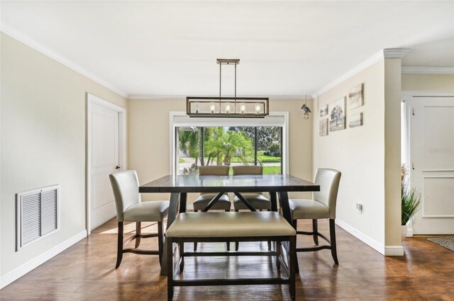 dining area featuring crown molding and dark wood-type flooring