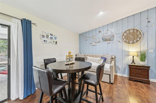 dining space featuring baseboards and wood finished floors