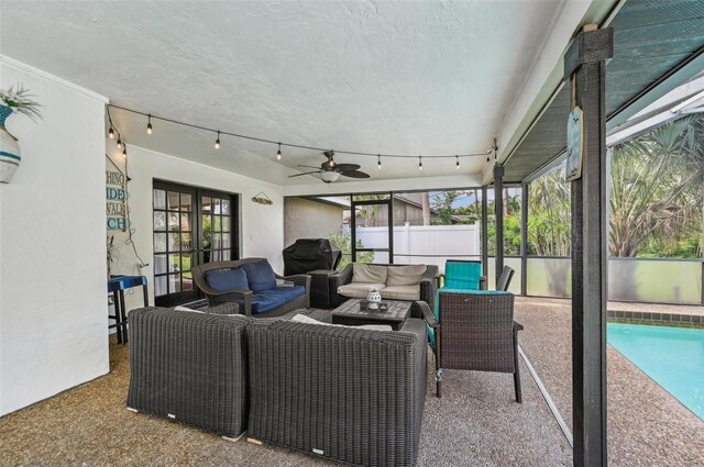 sunroom with plenty of natural light and ceiling fan