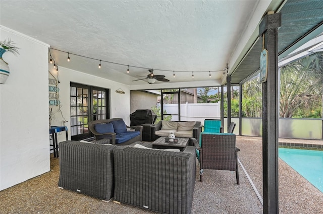 sunroom / solarium with rail lighting and ceiling fan