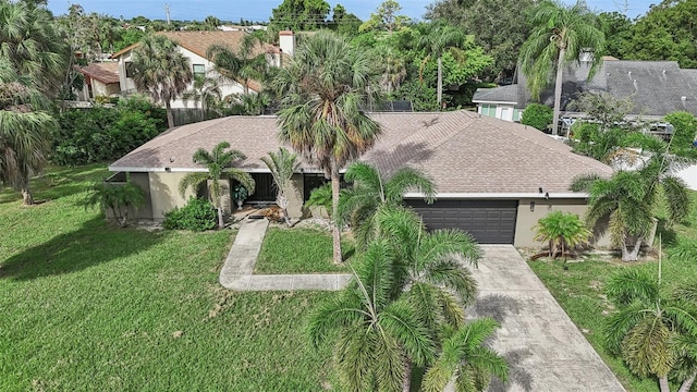 view of front of house with a front lawn and a garage