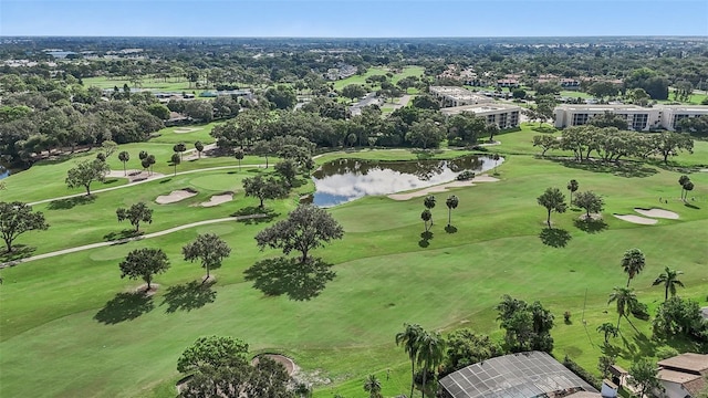 drone / aerial view with a water view and golf course view