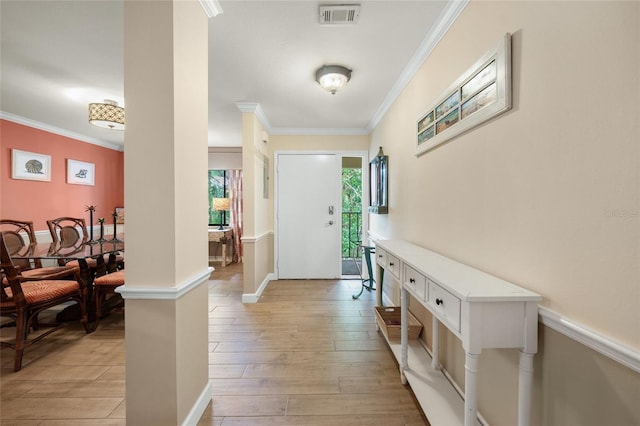 entryway featuring light wood-type flooring and crown molding