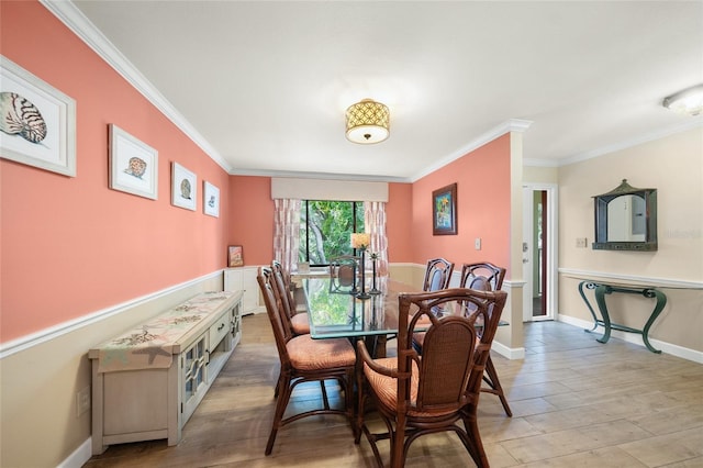 dining space featuring light wood-type flooring and crown molding