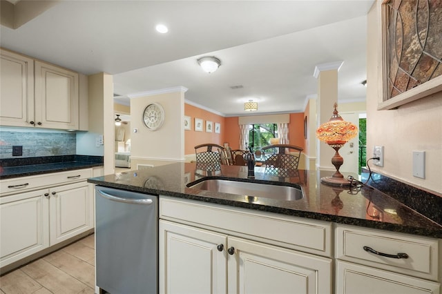 kitchen with ornamental molding, sink, light hardwood / wood-style flooring, dark stone countertops, and dishwasher