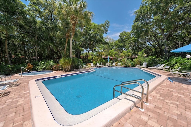 view of pool featuring a patio and a hot tub