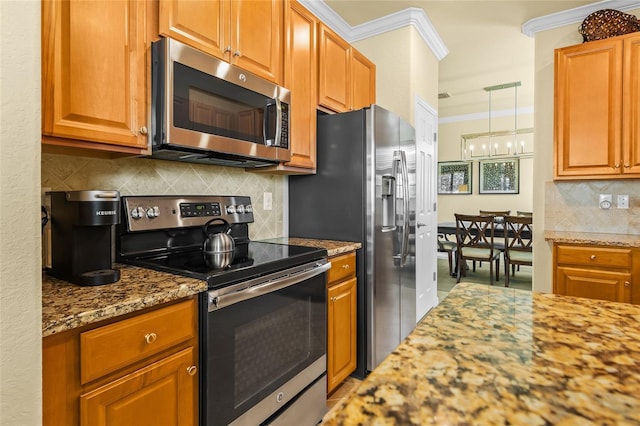 kitchen featuring light stone countertops, decorative backsplash, stainless steel appliances, and ornamental molding